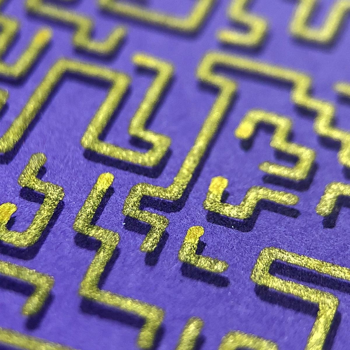 A close view of gold lines on purple paper. The lines move with random 90 degree rotations, but do not overlap. Some are short, others long enough to leave the frame of the image