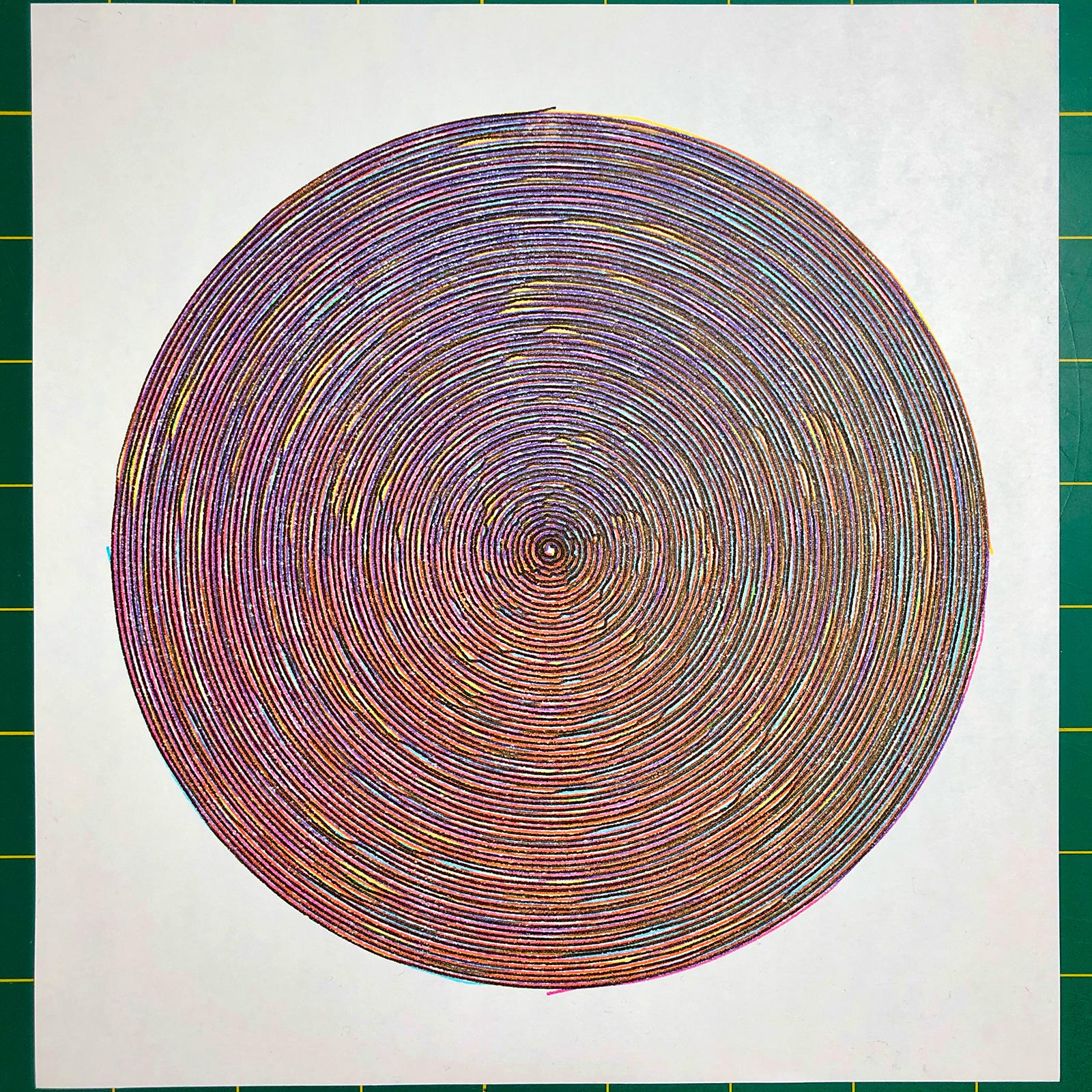 The complete multi-coloured spiral centered on white square paper