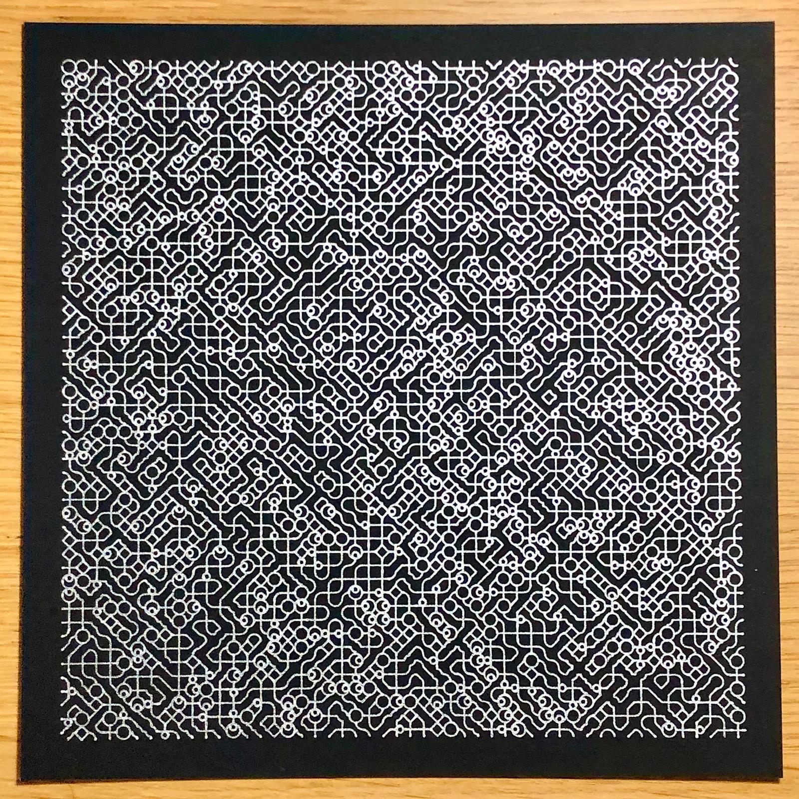 Black paper covered in a randomised pattern of various tiny diamond, circle, and line-based shapes, drawn in silver pen